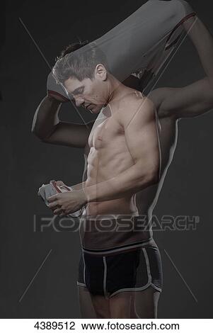 Man removing shirt View Large Photo Image Stock Image - Man removing shirt . Fotosearch