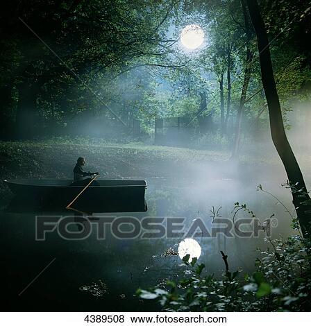 Man sitting in boat at full moon View Large Photo Image Stock Photo - Man sitting in boat at full moon . Fotosearch
