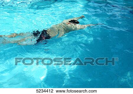 Man swimming under water View Large Photo Image Stock Image - Man swimming under water . Fotosearch
