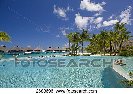 Man taking photograph of woman in swimming pool, Bora Bora Nui Hilton Resort, French Polynesia View Large Photo Image Stock Photograph - Man taking photograph of woman in swimming pool, Bora Bora Nui Hilton Resort, French Polynesia . Fotosearch