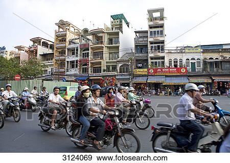 Moped drivers on a street in Ho Chi Minh City, Vietnam View Large Photo Image Stock Photo - Moped drivers on a street in Ho Chi Minh City, Vietnam . Fotosearch