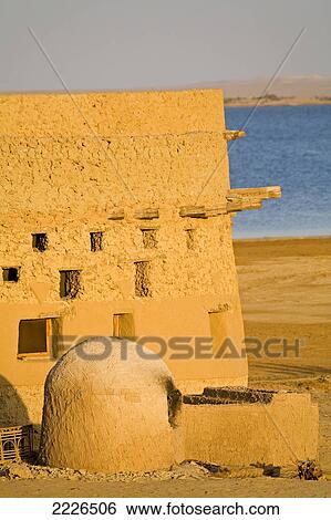 Mud brick house near lake in desert, Adrere Amellal, Siwa Oasis, Libyan Desert, Egypt View Large Photo Image Stock Photograph - Mud brick house near lake in desert, Adrere Amellal, Siwa Oasis, Libyan Desert, Egypt . Fotosearch