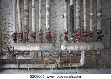 Network of pipes against brick wall View Large Photo Image Stock Photography - Network of pipes against brick wall . Fotosearch