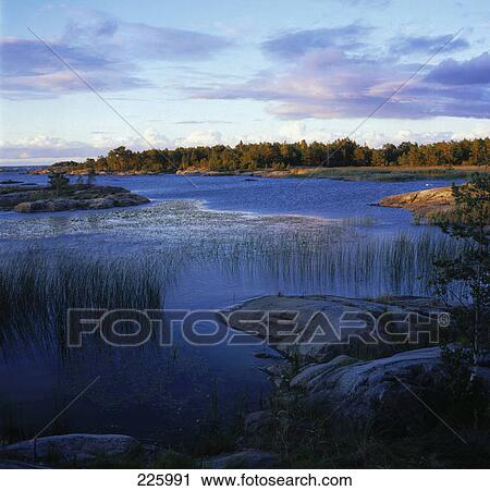 Stock Image - Panoramic view of river at dusk . Fotosearch