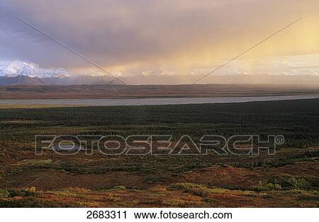 Stock Image - Panoramic view of snowcapped mountain range, Denali National Park, Alaska, USA . Fotosearch