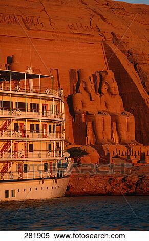 Passenger boat near ancient Egyptian temple, Great Temple of Rameses II, Lake Nasser, Abu Simbel, Egypt View Large Photo Image Stock Photography - Passenger boat near ancient Egyptian temple, Great Temple of Rameses II, Lake Nasser, Abu Simbel, Egypt . Fotosearch