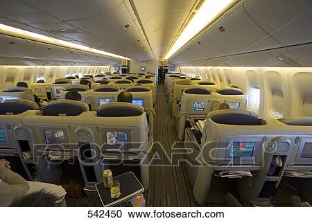 Passengers travelling in Boeing 777 commercial airplane View Large Photo Image Stock Image - Passengers travelling in Boeing 777 commercial airplane . Fotosearch