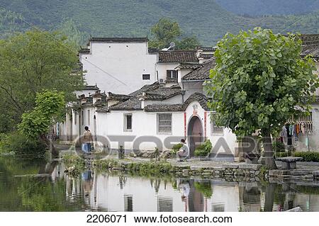 People in front of houses at waterfront, Hongcun, Anhui, China View Large Photo Image Stock Image - People in front of houses at waterfront, Hongcun, Anhui, China . Fotosearch
