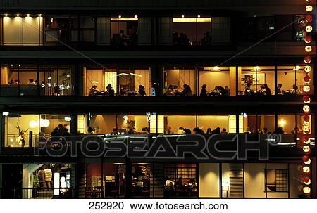 Stock Image - People in restaurant at night, Tokyo, Japan . Fotosearch