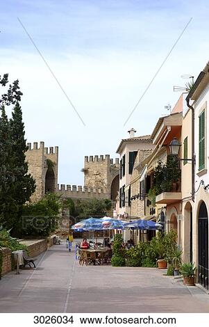 People sitting in a street cafe, city wall in the background, Alcudia, Majorca, Spain View Large Photo Image Picture - People sitting in a street cafe, city wall in the background, Alcudia, Majorca, Spain . Fotosearch