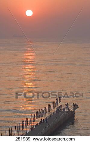People standing on pier at dusk, Durban, South Africa View Large Photo Image Stock Photo - People standing on pier at dusk, Durban, South Africa . Fotosearch