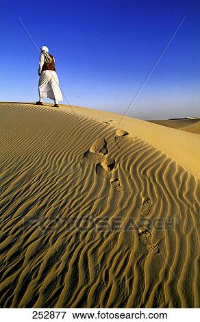 Person walking on sand dune, Siwa Oasis, Libyan Desert, Egypt View Large Photo Image Stock Photo - Person walking on sand dune, Siwa Oasis, Libyan Desert, Egypt . Fotosearch
