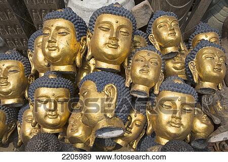 Pile of Buddha head sculptures View Large Photo Image Stock Photo - Pile of Buddha head sculptures . Fotosearch