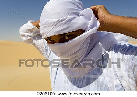 Portrait of man covering his face with headscarf, Great Sand Sea, Siwa Oasis, Libyan Desert, Egypt View Large Photo Image Stock Image - Portrait of man covering his face with headscarf, Great Sand Sea, Siwa Oasis, Libyan Desert, Egypt . Fotosearch