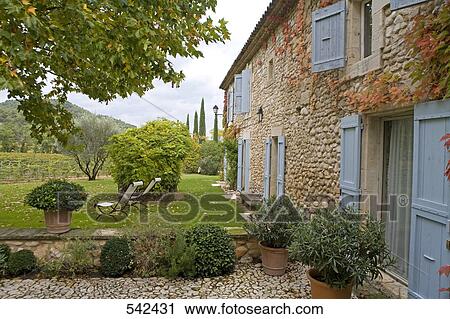 Potted plant in front of hotel, La Bastide De Marie, Menerbes, Luberon, Vaucluse, Provence-Alpes-Cote d'Azur, France View Large Photo Image Stock Image - Potted plant in front of hotel, La Bastide De Marie, Menerbes, Luberon, Vaucluse, Provence-Alpes-Cote d'Azur, France . Fotosearch