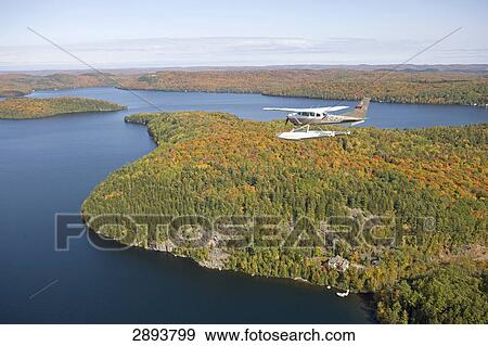 Propeller plane flying over Sacacomie lake, Canada, Quebec View Large Photo Image Stock Photo - Propeller plane flying over Sacacomie lake, Canada, Quebec . Fotosearch