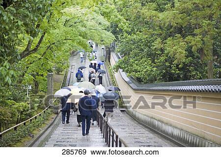 Rear view of people walking on stairs, Kinkaku-Ji Temple, Kyoto, Japan View Large Photo Image Stock Photo - Rear view of people walking on stairs, Kinkaku-Ji Temple, Kyoto, Japan . Fotosearch