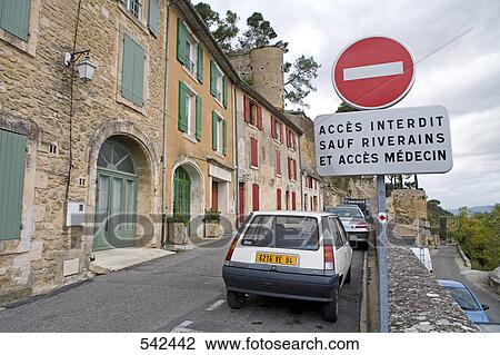 Road sign in front of building, Menerbes, Luberon, Vaucluse, Provence-Alpes-Cote d'Azur, France View Large Photo Image Stock Image - Road sign in front of building, Menerbes, Luberon, Vaucluse, Provence-Alpes-Cote d'Azur, France . Fotosearch