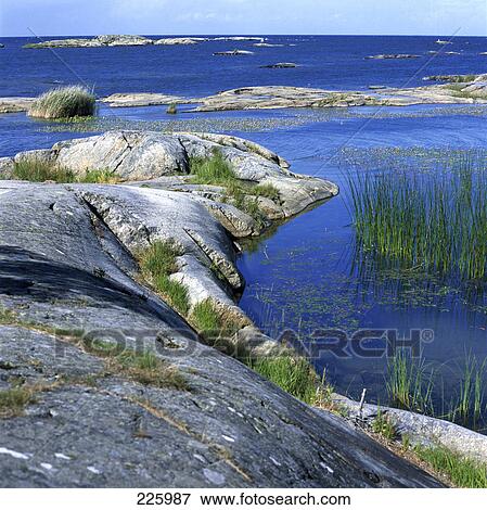 Stock Photo - Rocks submerged in lake, Lake Vaenern, Sweden . Fotosearch