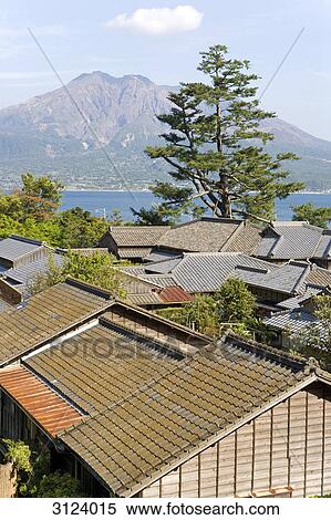 Rooftops in Kagoshima, volcano Sakurajima in the background, Japan, high angle view View Large Photo Image Stock Photography - Rooftops in Kagoshima, volcano Sakurajima in the background, Japan, high angle view . Fotosearch
