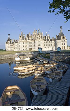 Stock Image - Rowing boats on moat in front of castle, Chateau De Chambord, Chambord, Loir-Et-Cher, France . Fotosearch