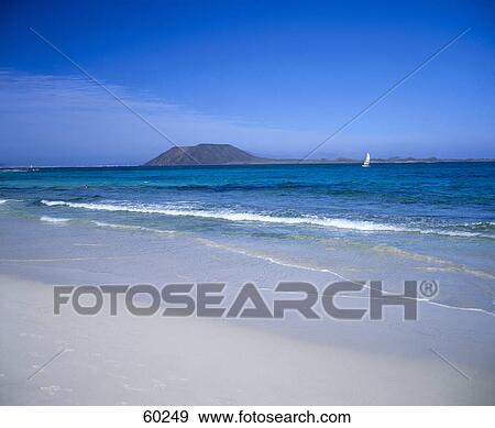 Sailboat in sea against blue sky, Fuerteventura, Canary Islands, Spain View Large Photo Image Stock Photo - Sailboat in sea against blue sky, Fuerteventura, Canary Islands, Spain . Fotosearch