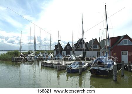 Stock Image - Sailboats at harbor, Bodden, Fischland-Darss-Zingst, Ahrenshoop, Nordvorpommern, Mecklenburg-Vorpommern, Germany . Fotosearch