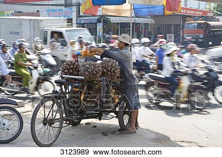 Salesman beside a trishaw with merchandise, Ho Chi Minh City, Vietnam View Large Photo Image Stock Photo - Salesman beside a trishaw with merchandise, Ho Chi Minh City, Vietnam . Fotosearch