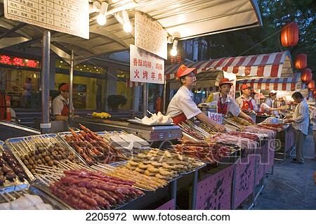 Salesmen standing at stalls in food market, Beijing, China View Large Photo Image Stock Image - Salesmen standing at stalls in food market, Beijing, China . Fotosearch