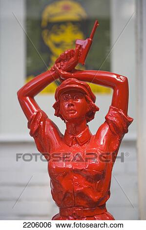 Stock Photograph - Sculpture of woman with gun, Beijing, China . Fotosearch