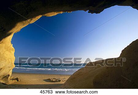 Stock Image - Sea viewed from natural arch, Fontanilla Beach, Conil de la Frontera, Costa de la Luz, Andalusia, Spain . Fotosearch