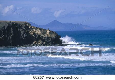 Sea waves crashing on a rocky coast, Fuerteventura, Canary Islands, Spain View Large Photo Image Stock Photo - Sea waves crashing on a rocky coast, Fuerteventura, Canary Islands, Spain . Fotosearch