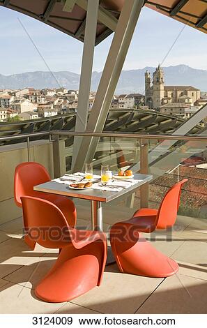 Set table and chairs on a roof top terrace, Elciego, Spain View Large Photo Image Stock Photo - Set table and chairs on a roof top terrace, Elciego, Spain . Fotosearch
