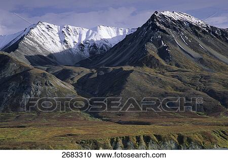 Stock Image - Snowcapped mountain under blue sky, Mt Eielson, Denali National Park, Alaska, USA . Fotosearch