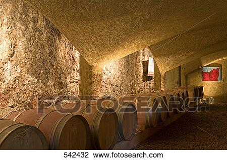 Stack of wine barrel inside cellar, Menerbes, France View Large Photo Image Stock Image - Stack of wine barrel inside cellar, Menerbes, France . Fotosearch