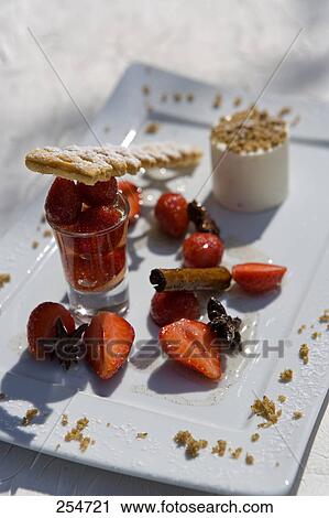 Stock Image - Strawberries and cracker with cinnamon stick on plate . Fotosearch