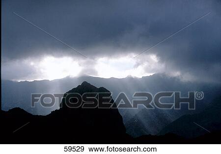 Sun rays on a mountain range, Tenerife, La Gomera, Canary Islands, Spain View Large Photo Image Stock Photo - Sun rays on a mountain range, Tenerife, La Gomera, Canary Islands, Spain . Fotosearch