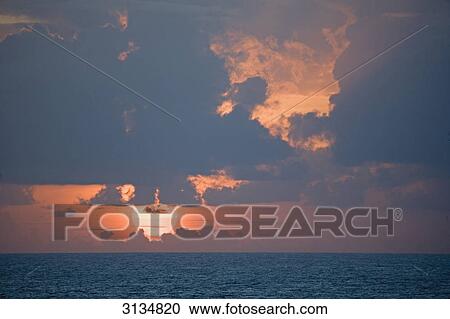 Stock Image - Sunset at Pacific, French Polynesia . Fotosearch