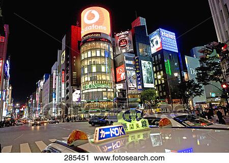 Taxi on city road at night, San-Ai Building, Tokyo Prefecture, Japan View Large Photo Image Stock Image - Taxi on city road at night, San-Ai Building, Tokyo Prefecture, Japan . Fotosearch