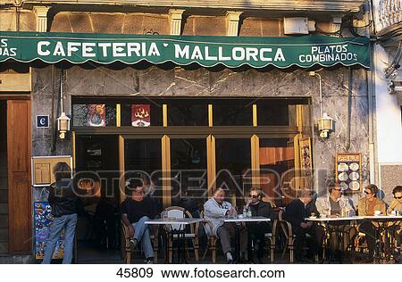 Tourists at out door cafe, Port de Soller, Mallorca, Baleares, Spain View Large Photo Image Stock Photo - Tourists at out door cafe, Port de Soller, Mallorca, Baleares, Spain . Fotosearch