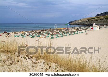 Tourists at the beach of Cala Mesquida, Majorca, Spain View Large Photo Image Stock Photography - Tourists at the beach of Cala Mesquida, Majorca, Spain . Fotosearch