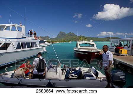 Tourists in boat at harbor, Bora Bora, Society Island, French Polynesia View Large Photo Image Picture - Tourists in boat at harbor, Bora Bora, Society Island, French Polynesia . Fotosearch