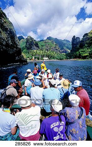 Tourists in passenger boat sailing towards coast, Marquesas Islands, French Polynesia View Large Photo Image Stock Photograph - Tourists in passenger boat sailing towards coast, Marquesas Islands, French Polynesia . Fotosearch