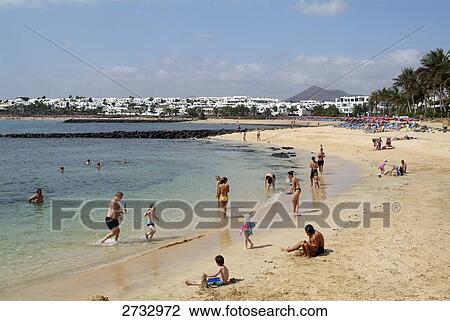 Tourists on beach, Costa Teguise, Playa des Cucharas, Lanzarote, Canary Islands, Spain View Large Photo Image Stock Image - Tourists on beach, Costa Teguise, Playa des Cucharas, Lanzarote, Canary Islands, Spain . Fotosearch