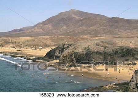 Stock Photo - Tourists on beach, Papagayo Beach, Lanzarote, Canary Islands, Spain . Fotosearch