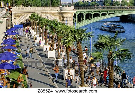 Picture - Tourists on coast near bridge, Seine Rive, Paris, Ile-de-France, France . Fotosearch