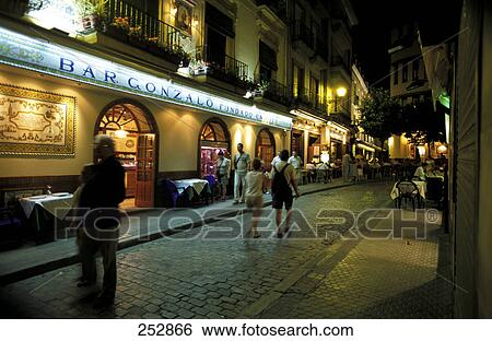 Tourists walking on cobblestone path in market, Andalusia, Spain View Large Photo Image Stock Photograph - Tourists walking on cobblestone path in market, Andalusia, Spain . Fotosearch