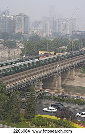 Train crossing bridge over highway, China View Large Photo Image Picture - Train crossing bridge over highway, China . Fotosearch