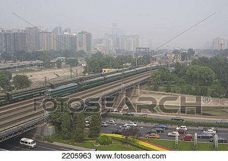 Train crossing bridge over highway, China View Large Photo Image Stock Image - Train crossing bridge over highway, China . Fotosearch