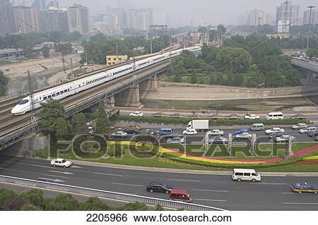 Train crossing bridge over highway, China View Large Photo Image Stock Photograph - Train crossing bridge over highway, China . Fotosearch